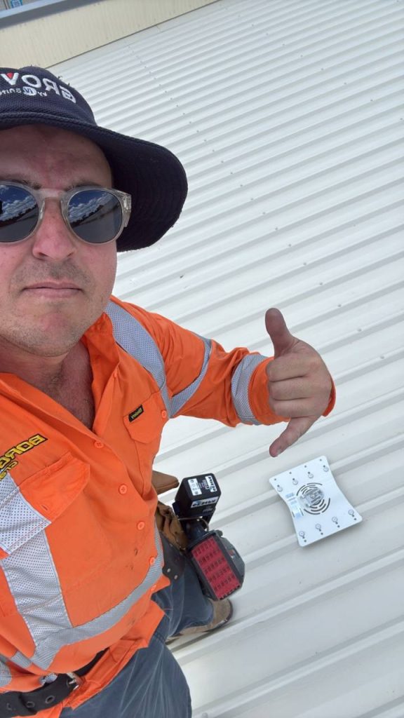 Roofing contractor giving a thumbs up on a project site in Australia.